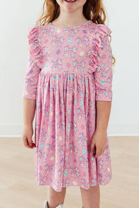 Girls pink twirl ruffle dress with 3/4 sleeves and colorful bow print by Mila & Rose