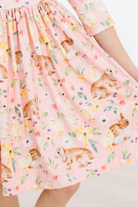 Girls pink twirl ruffle dress with 3/4 sleeves and bunny and chick print by Mila & Rose