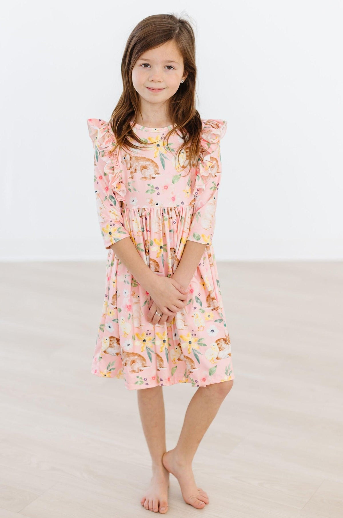 Girls pink twirl ruffle dress with 3/4 sleeves featuring a playful animal print