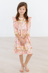 Girls pink twirl ruffle dress with 3/4 sleeves featuring a playful animal print