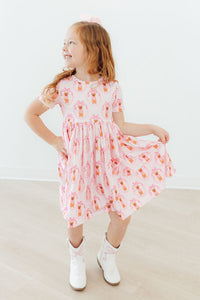 Girls pink twirl pocket dress with short sleeves and orange floral print, toddler size