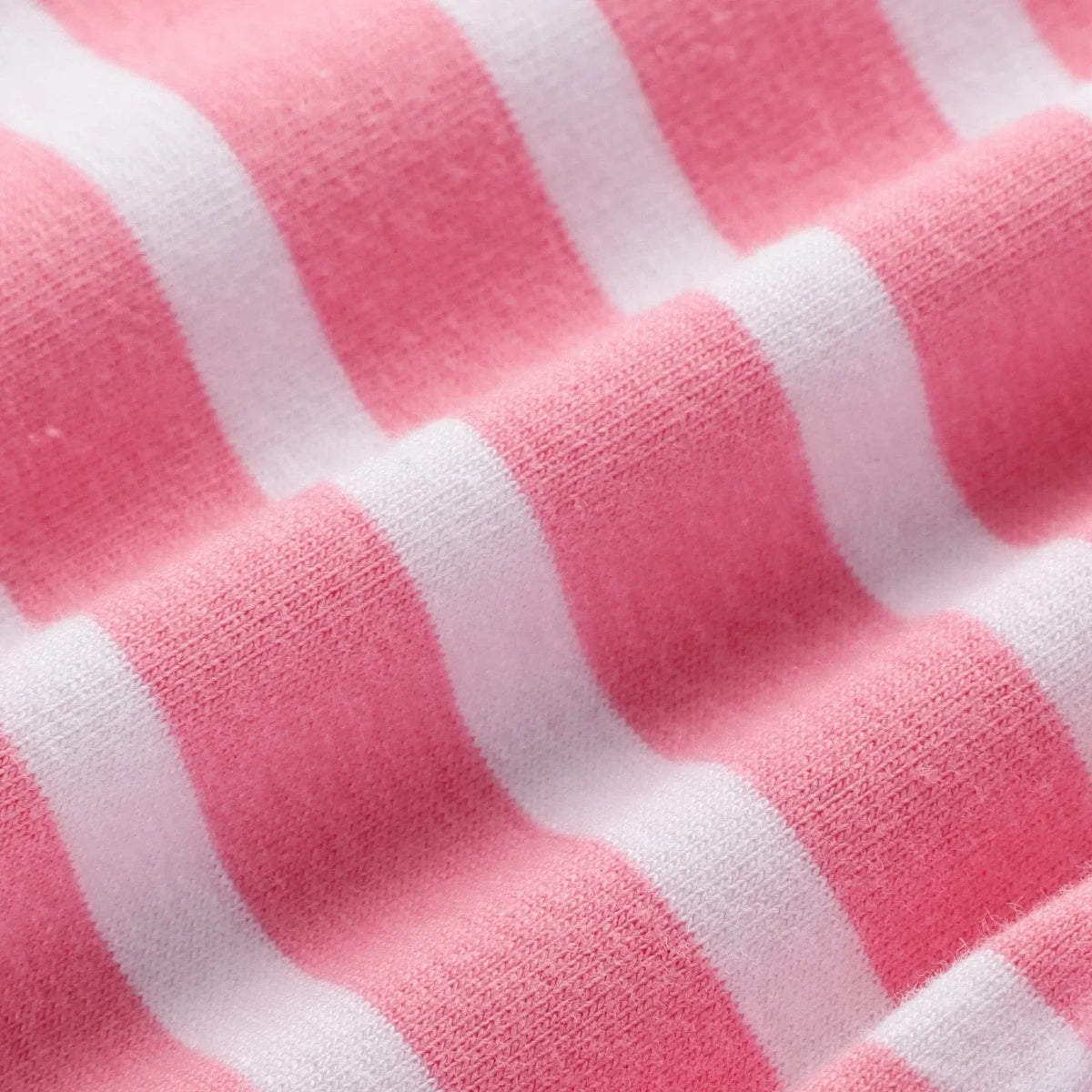 Close-up of pink and white striped girls floral cotton leggings fabric for babies and kids