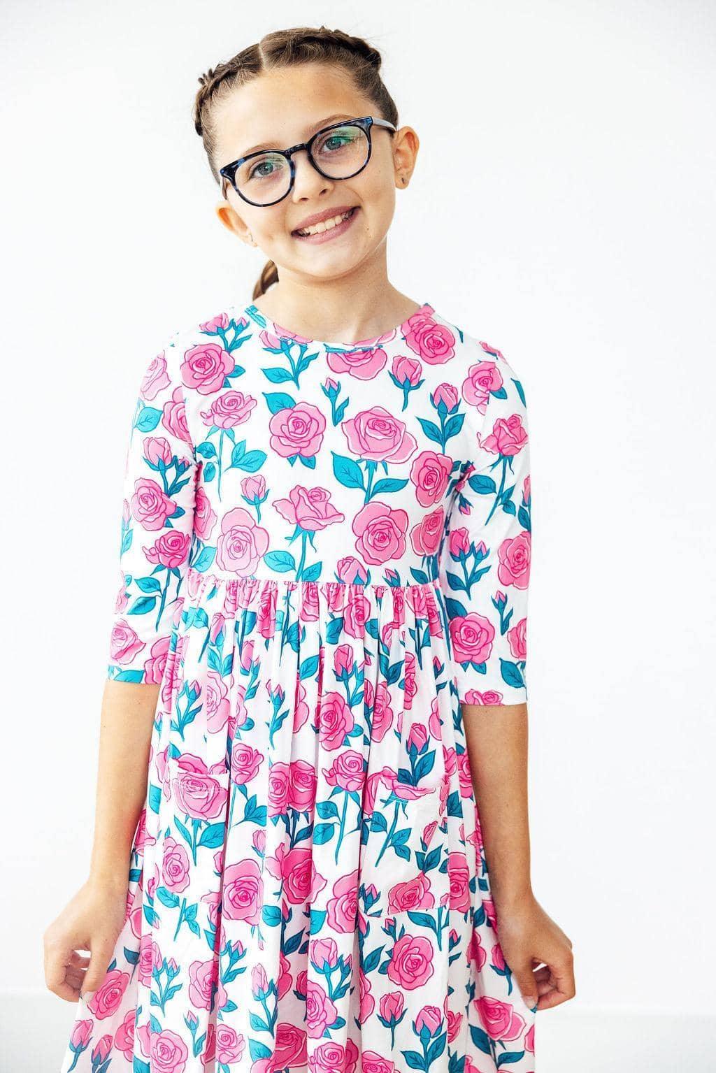 Girls floral pocket twirl dress in white with pink roses and green leaves, sleeves for ages 6-8