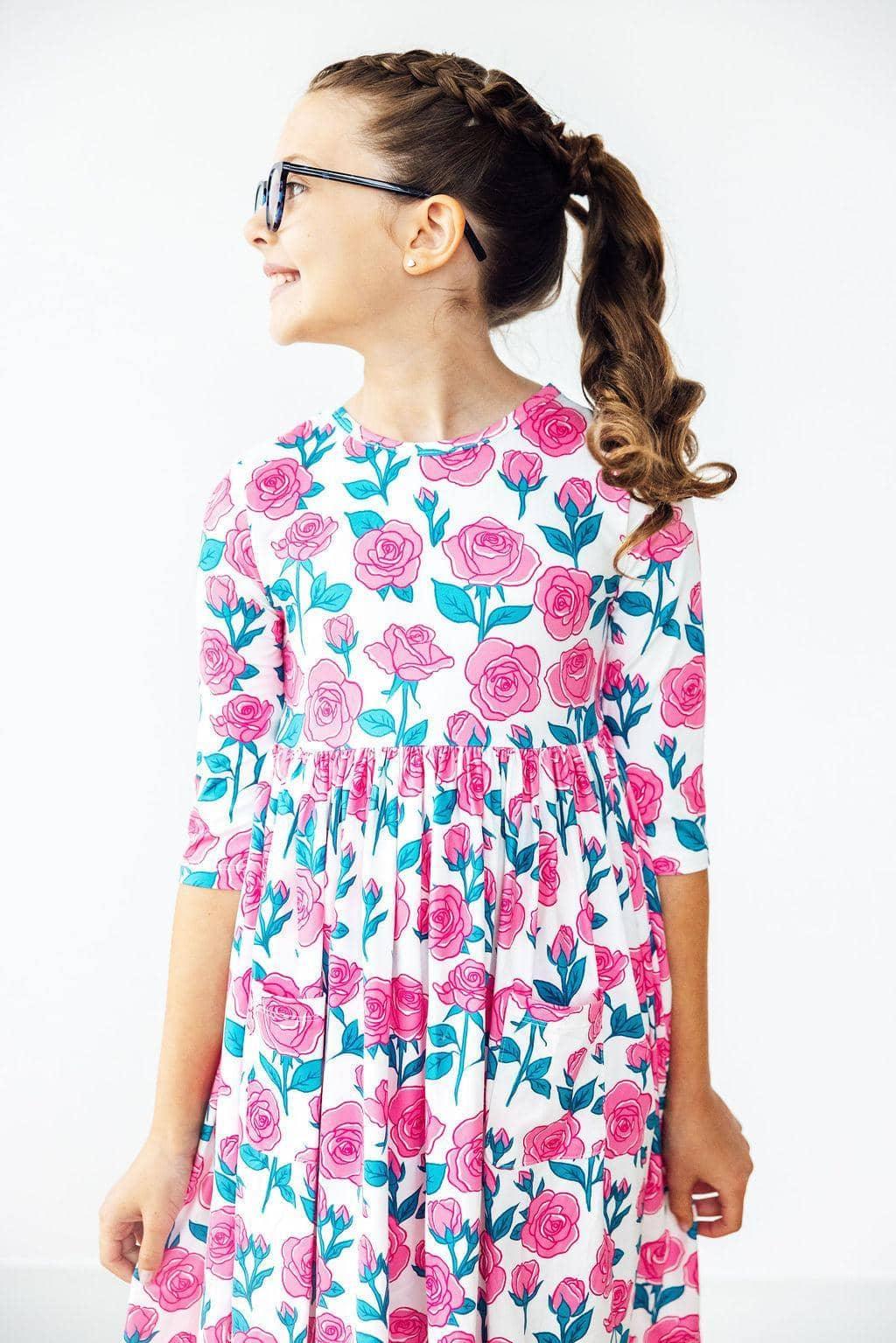 Girls floral pocket twirl dress in white with pink roses and teal leaves for young girls