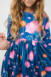 Girls floral twirl dress in blue with pink and orange flowers, sleeves, pocket detail
