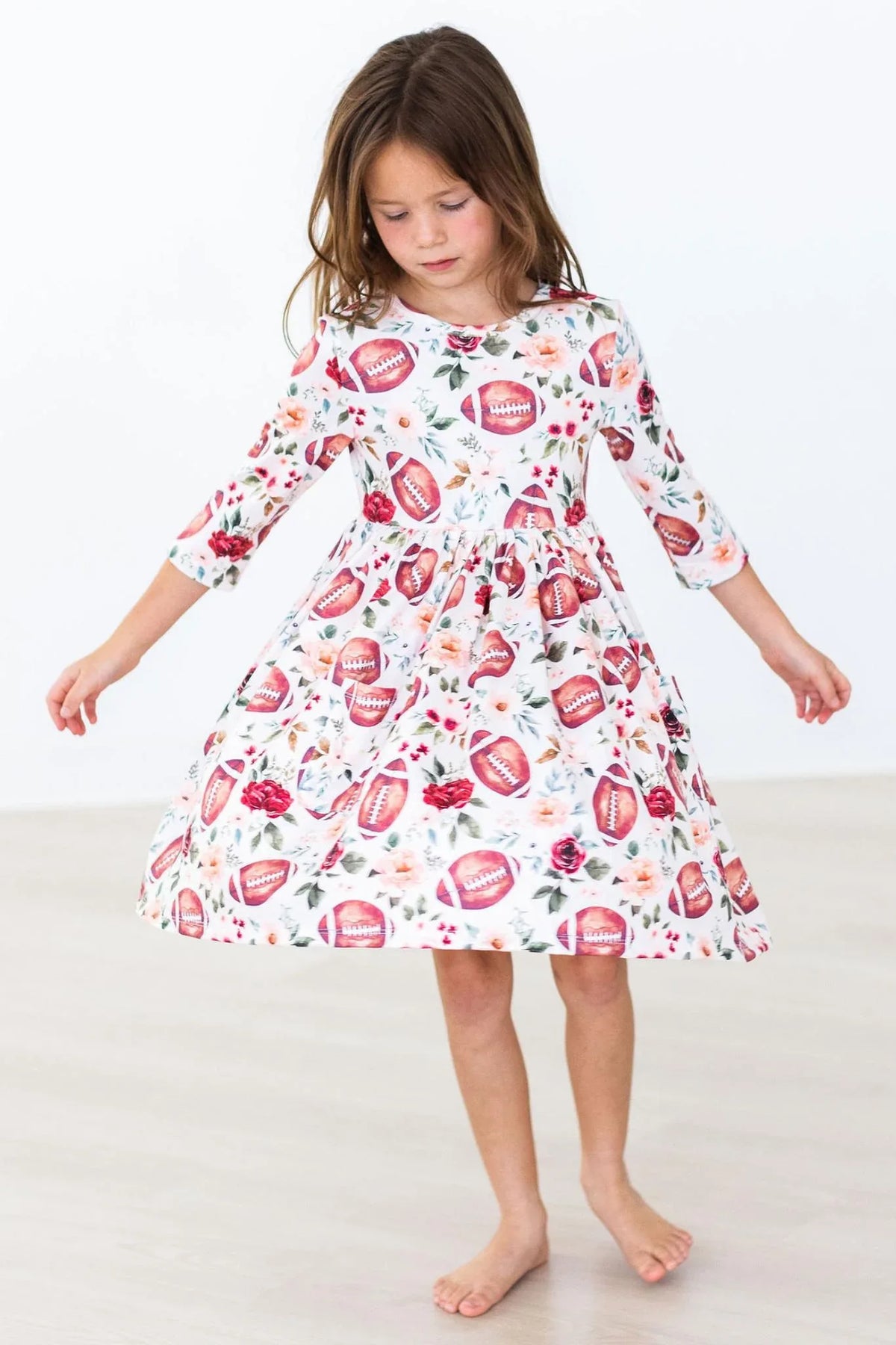 Girls white 3/4 sleeve twirl dress with football and floral print age 3 to 4 years