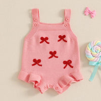 pink girls knitted romper overalls with red bow accents and button straps for infants