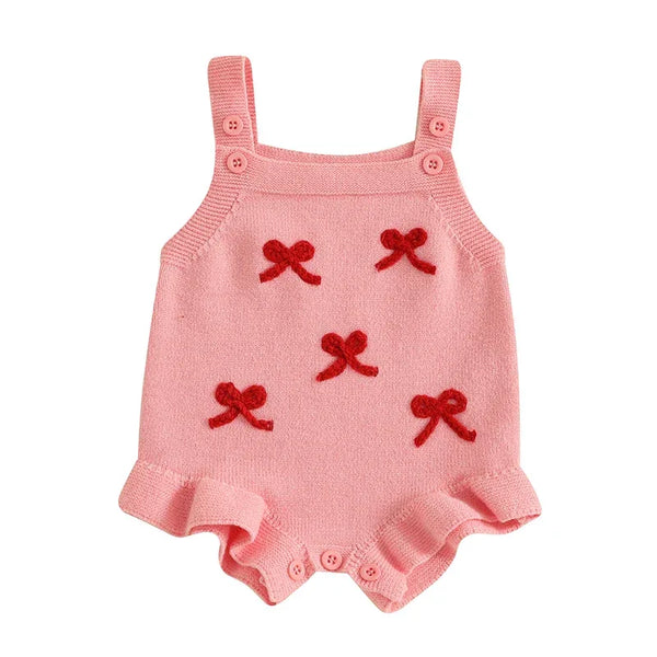 pink girls knitted romper overalls for babies with red bow details and button straps
