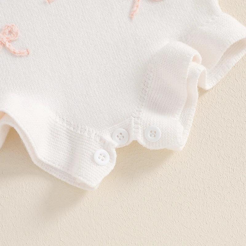 white girls knitted romper overalls for babies with button closure and pink embroidery detail