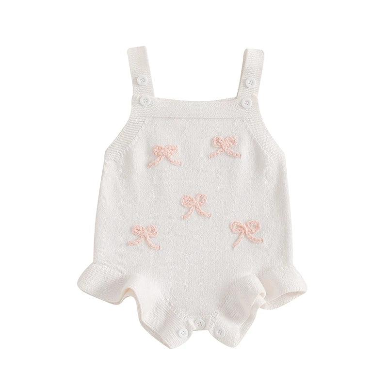 girls white knitted romper overalls with pink bow details, suitable for babies and toddlers