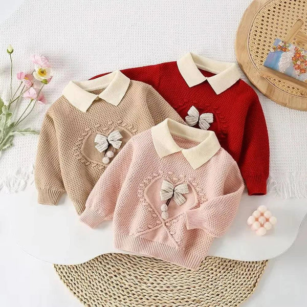 Knitted skirt set for girls featuring three pastel sweaters in beige pink and red with white collars and bow heart detail for toddlers