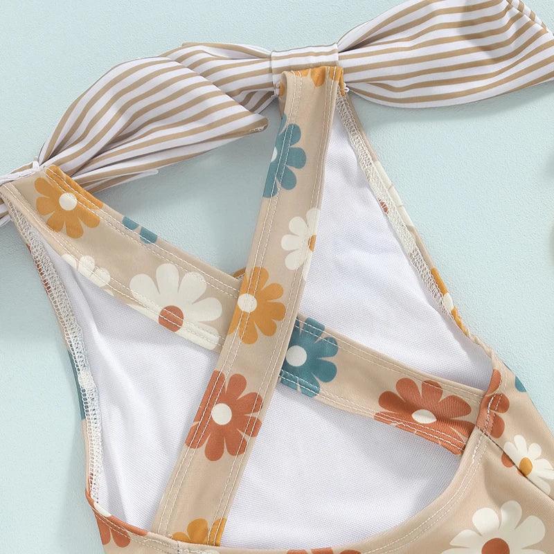 Girls one piece swimsuit in beige with multicolor floral print and striped bow detail