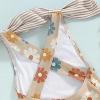 Girls one piece swimsuit in beige with multicolor floral print and striped bow detail