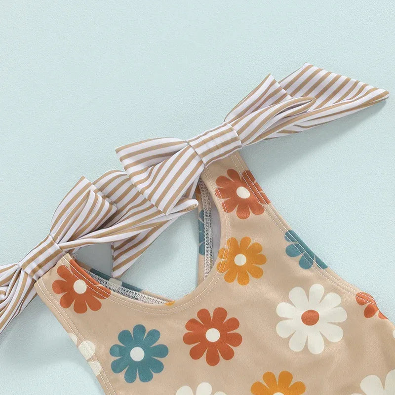 Girls one piece swimsuit beige with multicolor flower print and striped bow straps for toddlers
