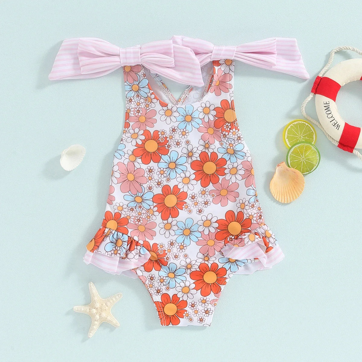 Girls one piece swimsuit with colorful floral pattern and pink striped bow straps for toddlers
