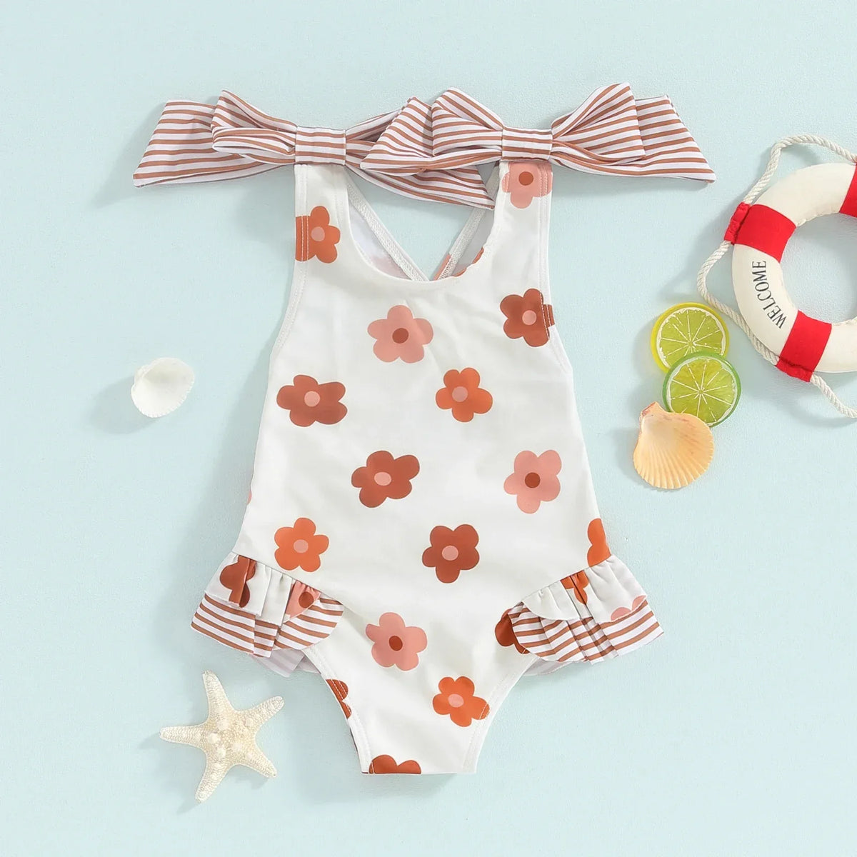Girls one piece swimsuit in white with brown and pink flowers and striped bow straps for toddlers