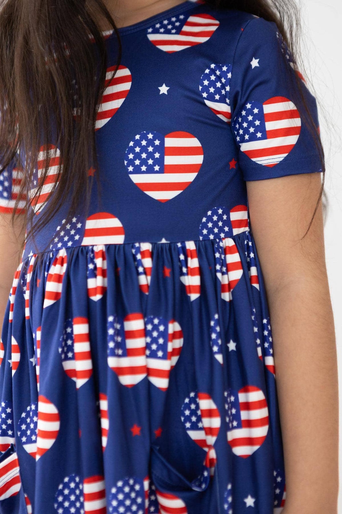Girls patriotic twirl dress in blue with American flag heart print and short sleeves