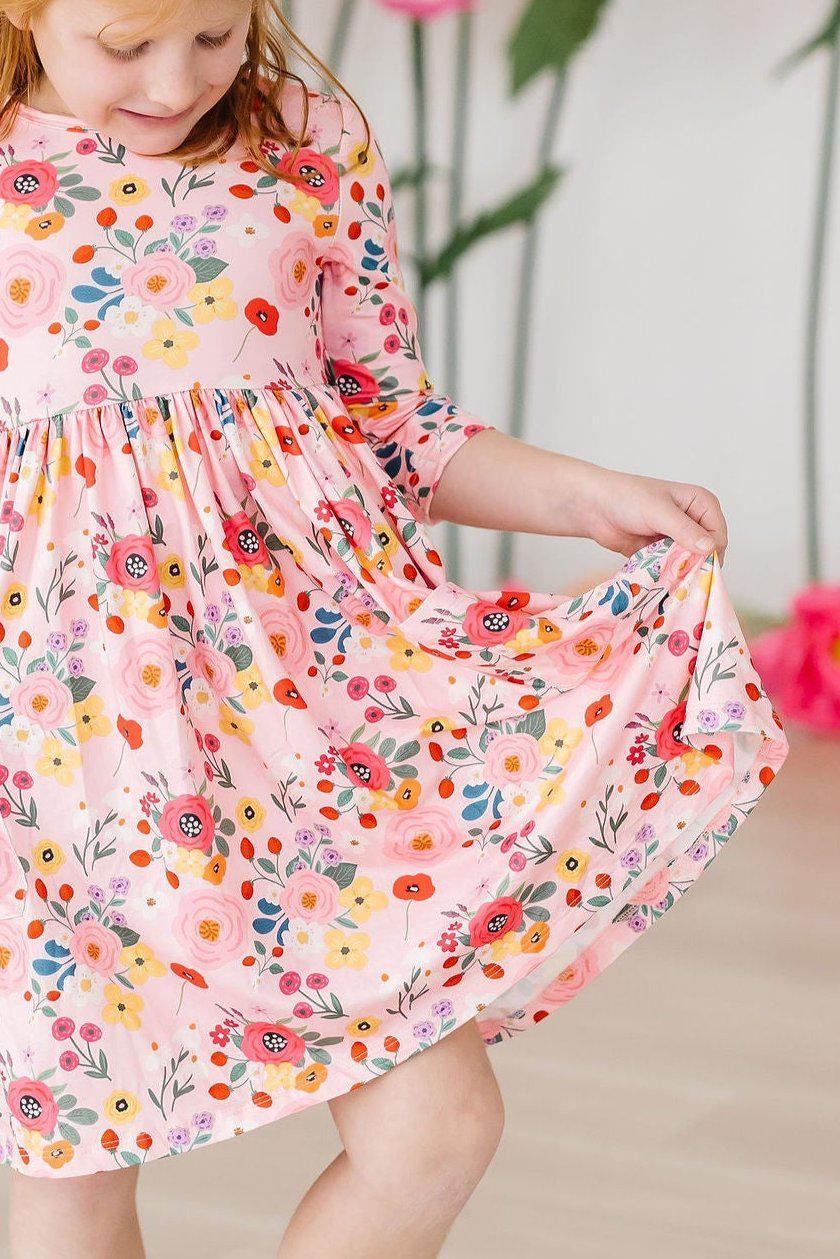 Girls pink floral twirl dress with 3/4 sleeves and pocket in a playful fit for young girls