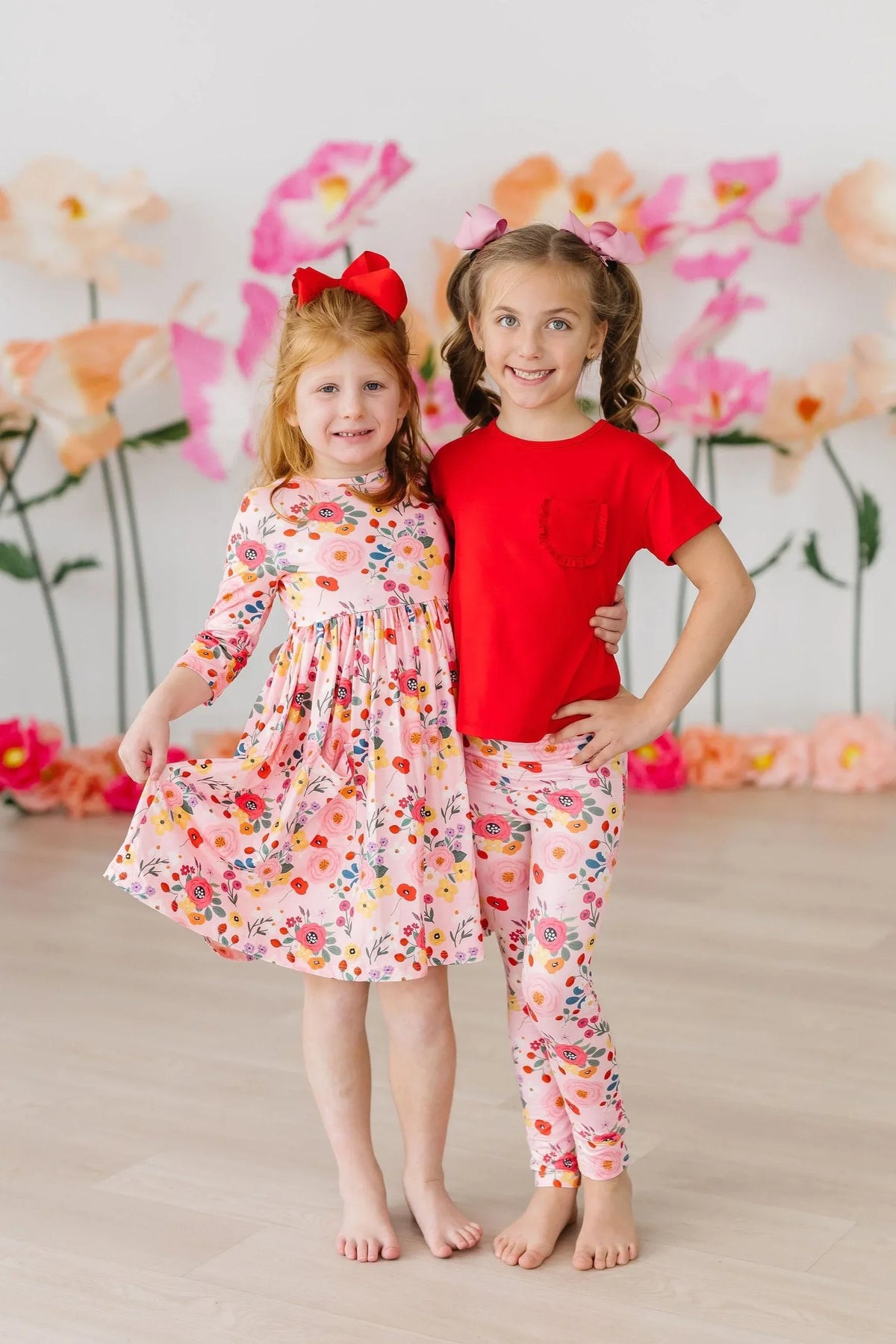 Girls pink floral twirl dress with 3/4 sleeves, size for young girls, featuring a playful pocket detail