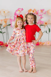 Girls pink floral twirl dress with 3/4 sleeves, size for young girls, featuring a playful pocket detail
