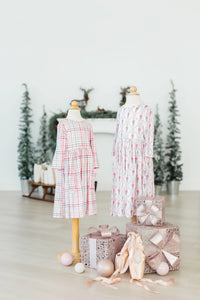 Girls pink plaid twirl dress 3/4 sleeve with pockets on child mannequin in holiday setting