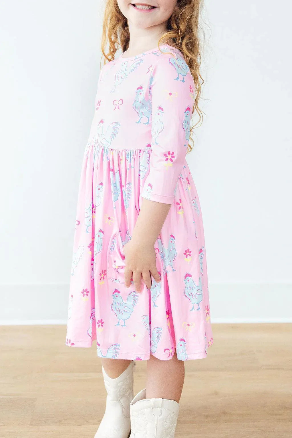 Girls pink twirl dress by Mila & Rose with 3/4 sleeves and rooster print in toddler size