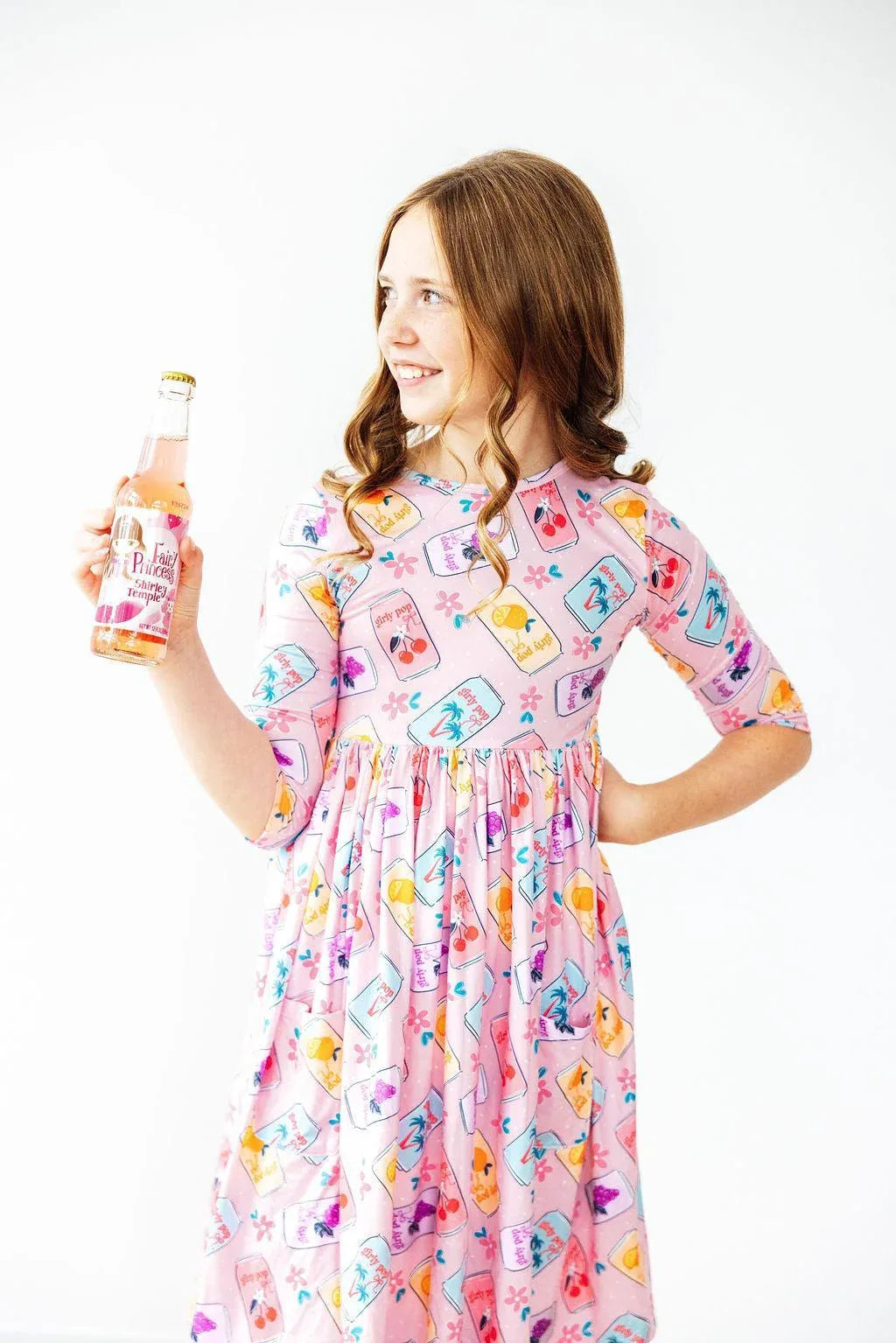Girls pink twirl dress with colorful bottle print, 3/4 length sleeves, and gathered waist