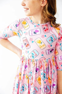 Girls pink twirl dress with 3/4 sleeves featuring colorful fruit jar print for kids