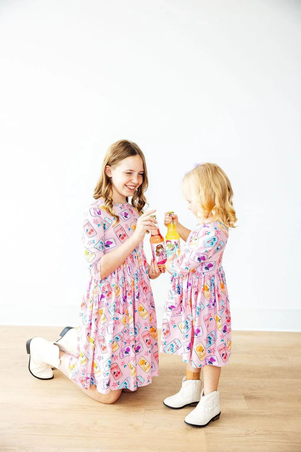 Girls pink twirl dress with colorful print, 3/4 sleeves, knee-length for young girls