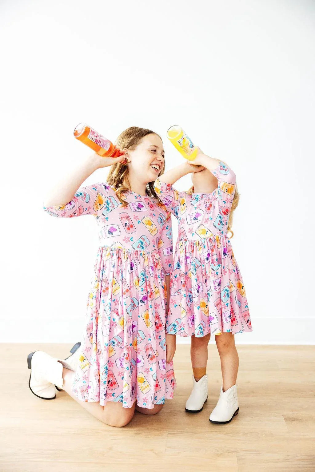 Girls pink twirl dress 3/4 sleeve with colorful cartoon print, knee and midi length, playful pocket detail for kids