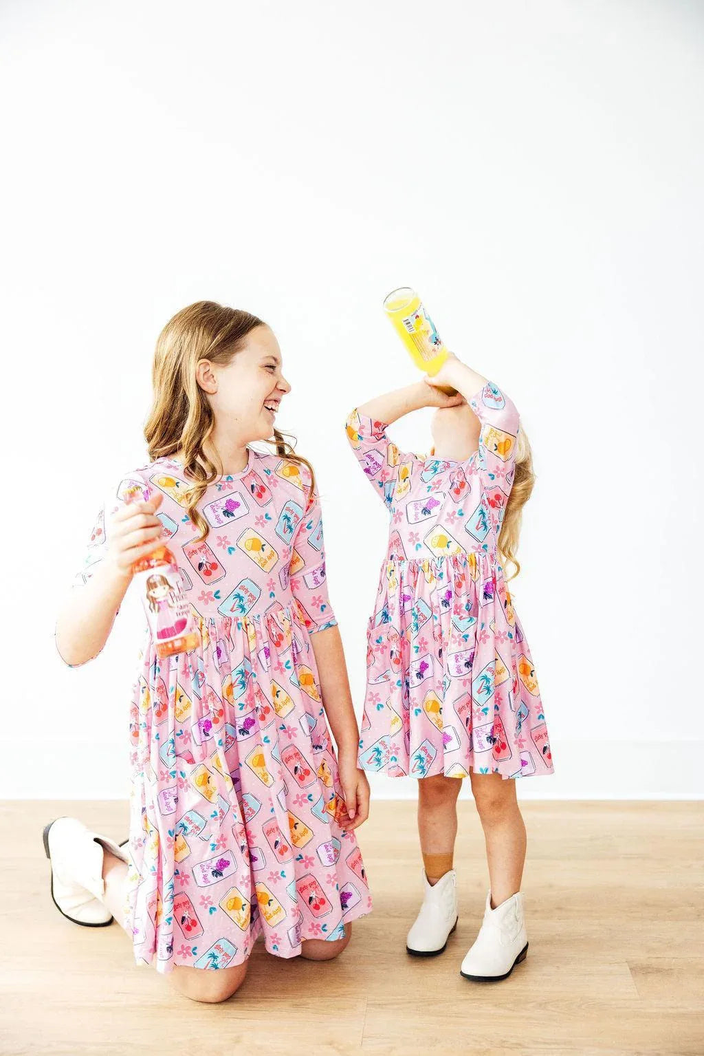 Girls pink twirl dress by Mila & Rose with colorful pattern and 3/4 sleeves for kids
