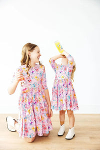 Girls pink twirl dress by Mila & Rose with colorful pattern and 3/4 sleeves for kids