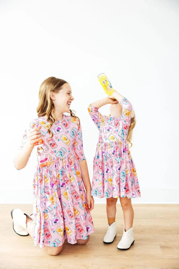 Girls pink twirl dress by Mila & Rose with colorful pattern and 3/4 sleeves for kids
