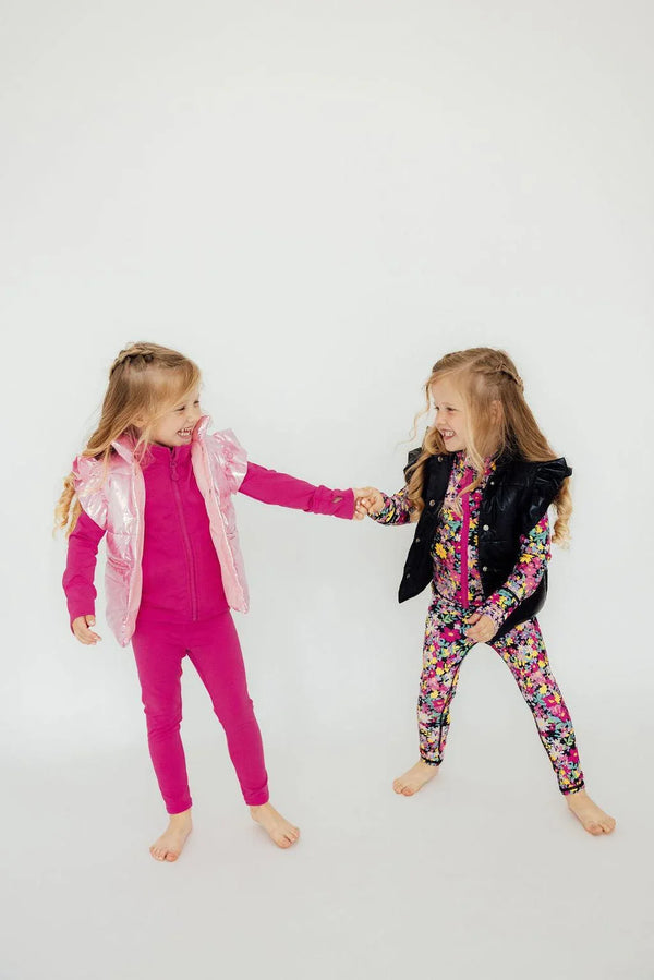 Girls pink and black puffer vests by Mila Rose, sleeveless, worn with colorful outfits