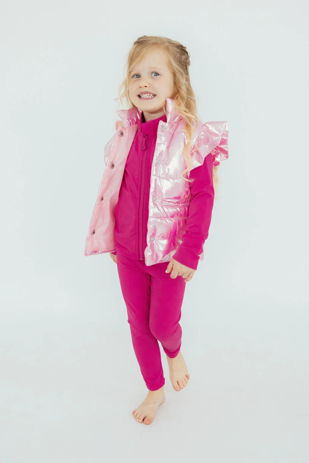 Girls pink holographic puffer vest with ruffle details in toddler size