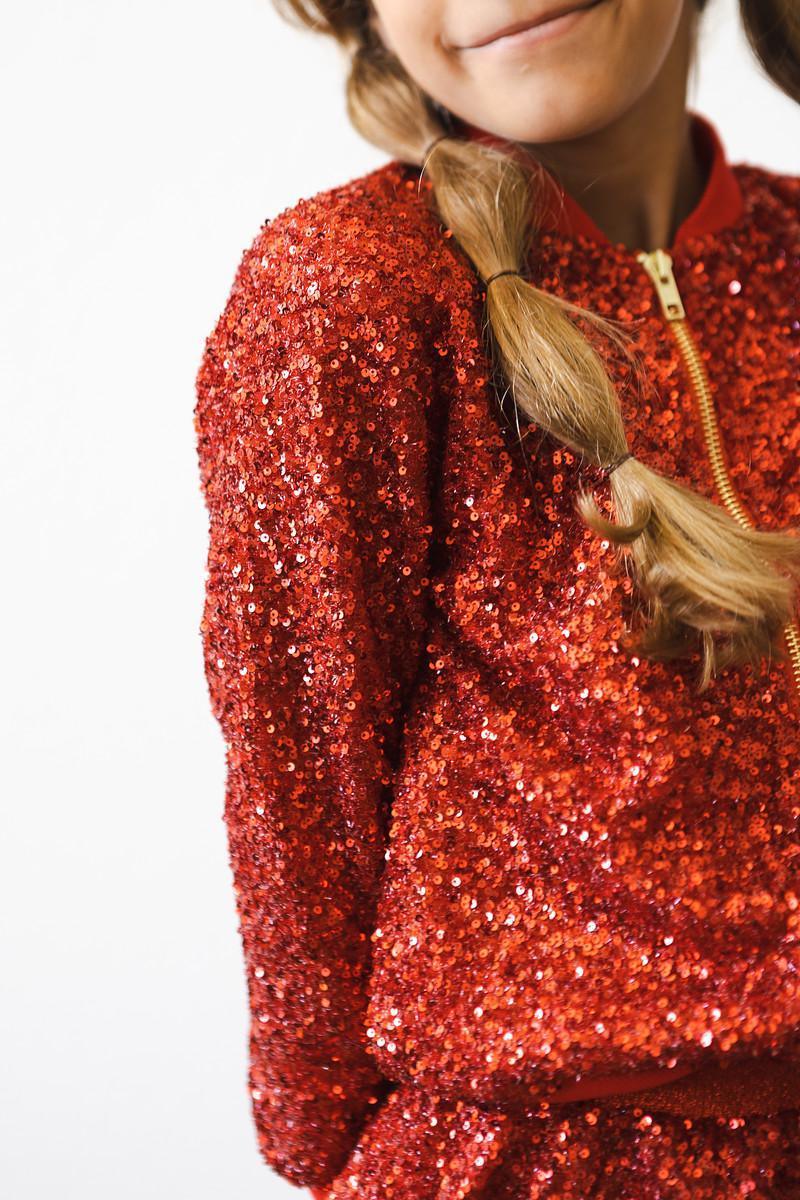 Girls red sequin jacket with long sleeves and zipper, detailed with shiny red sequins for a sparkling look