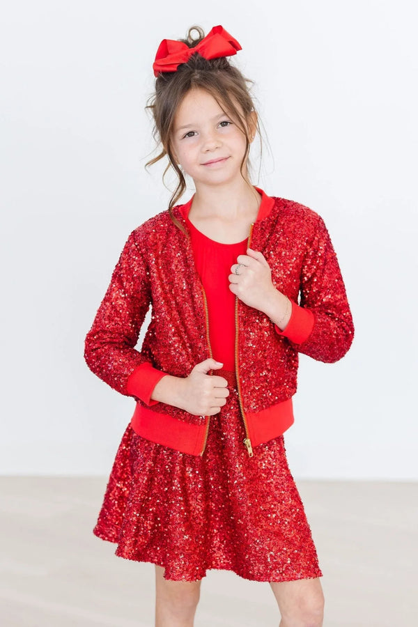 Girls red sequin jacket long sleeve worn by young girl with matching red dress and bow