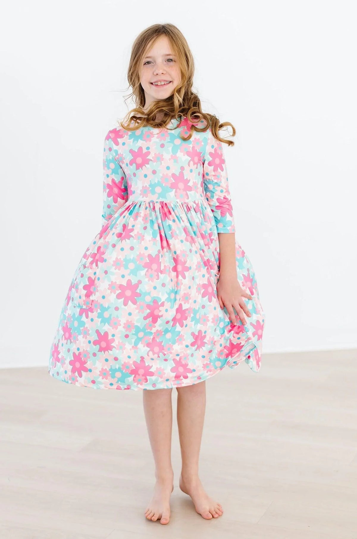 Girls retro floral twirl dress in pastel pink and blue with 3 quarter sleeves for young girls