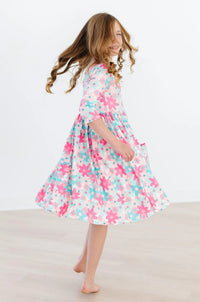 Girls retro floral twirl dress in pink and teal with 3/4 sleeves and pockets for kids