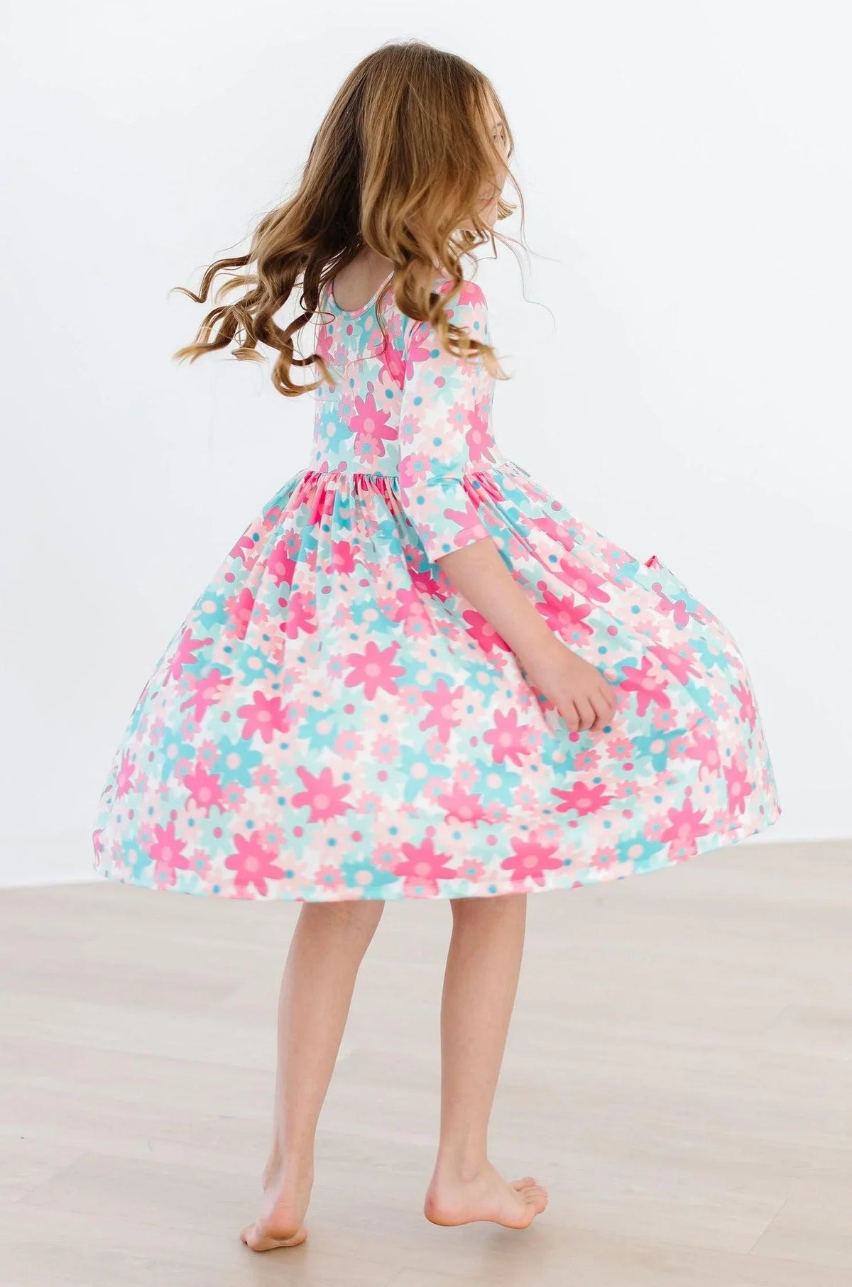 Girls retro floral twirl dress by Mila & Rose in pastel pink and blue with 3/4 sleeves for young girls