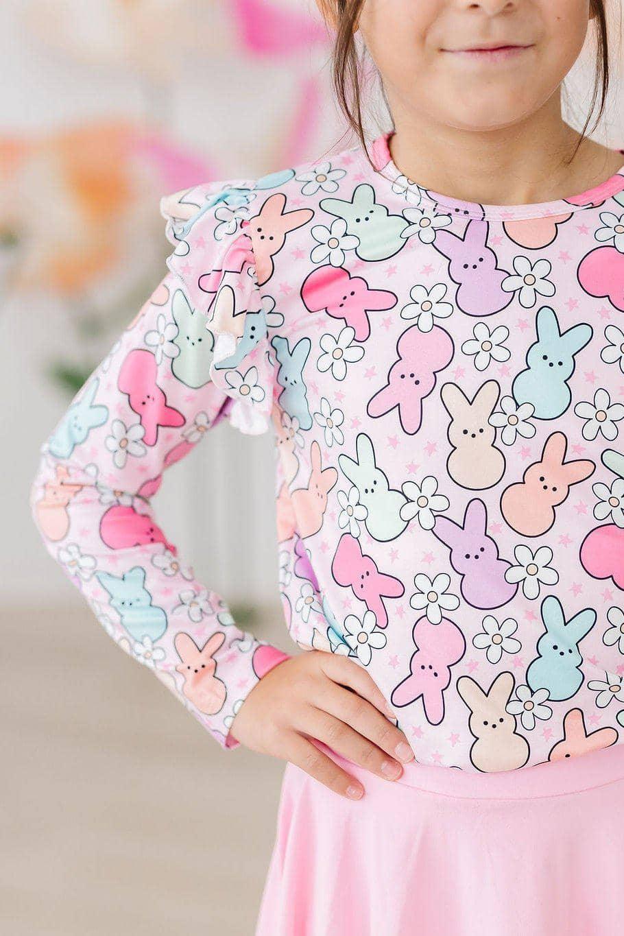 girl wearing pastel pink and blue girls ruffle long sleeve tee with bunny and flower print