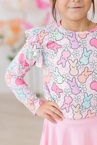 girl wearing pastel pink and blue girls ruffle long sleeve tee with bunny and flower print