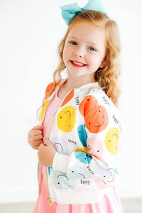 Girls white satin jacket with colorful smiley face prints, zipper front, worn by young child