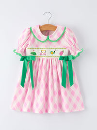 Pink and white plaid girls smocked golf dress with green collar and bows for toddlers