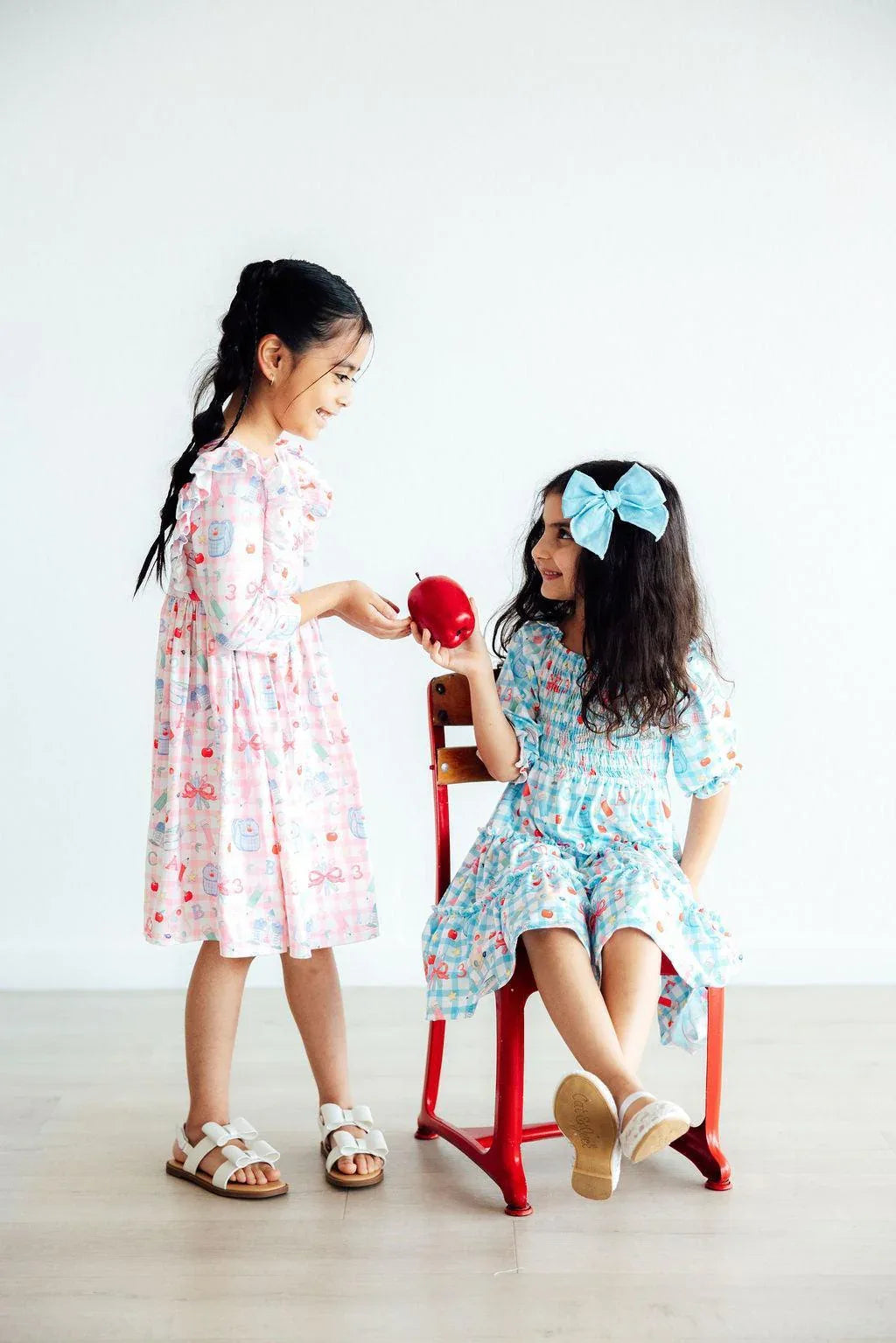 Girls smocked ruffle dress in pastel pink and blue, toddler and young girl sizes with floral patterns