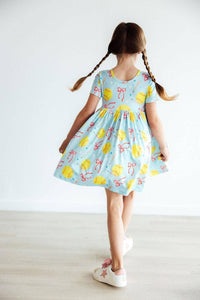 Girls light blue twirl pocket dress with short sleeves and pink bows softball print