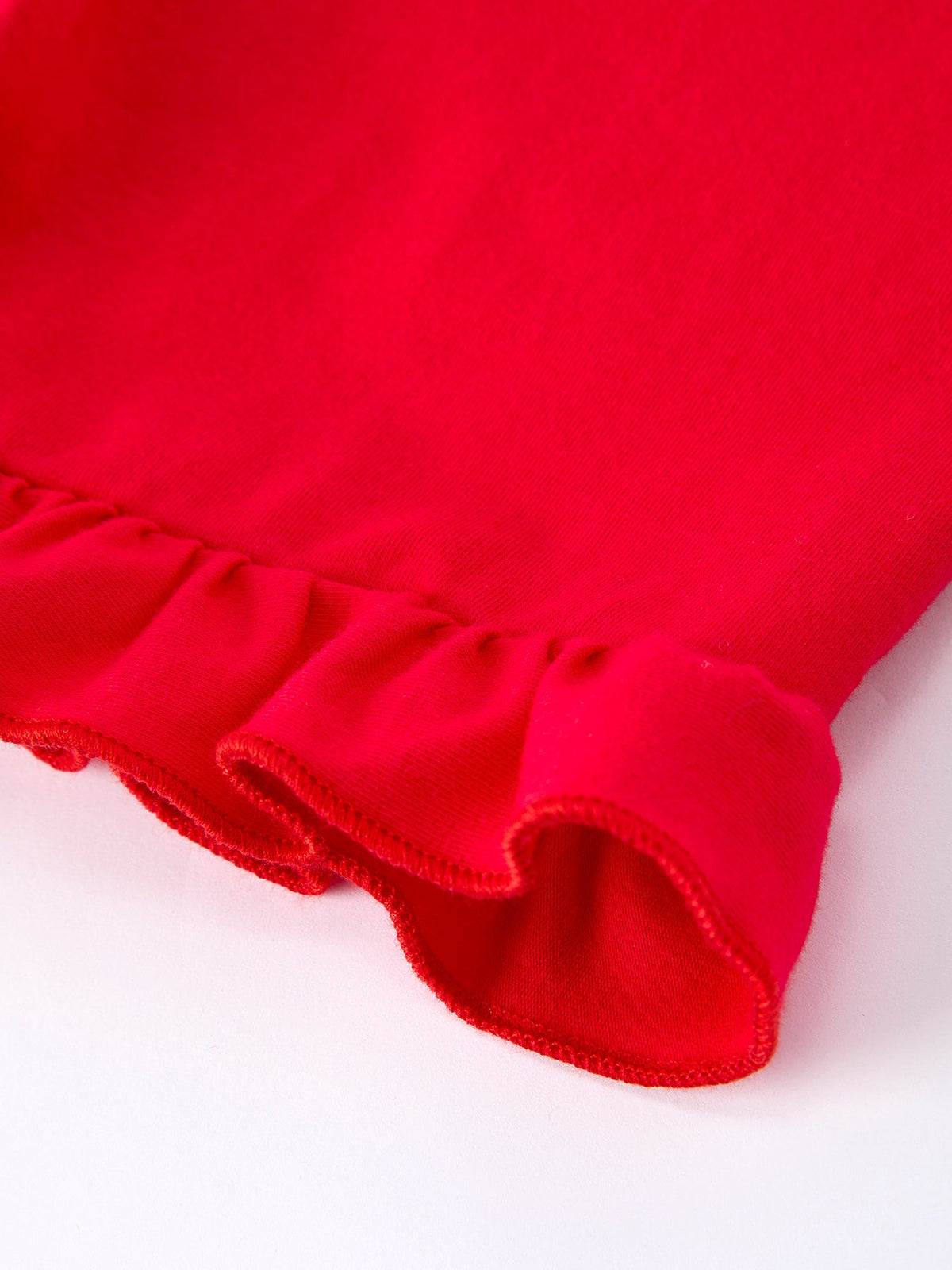 Close-up of girls red girls strawberry applique shorts set with ruffle detail on the hem