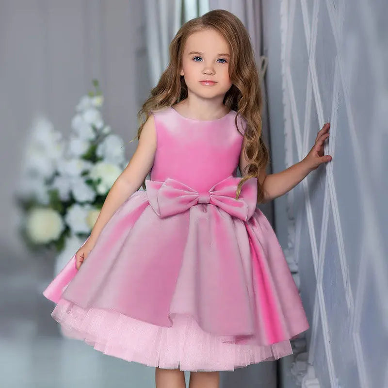 Pink girls tiered party dress with large bow detail for toddlers and young girls