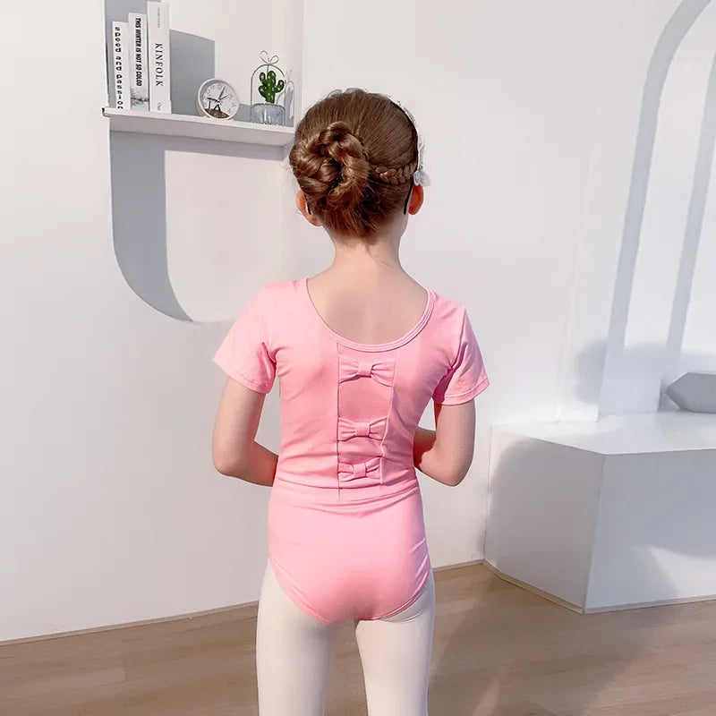 girls pink tutu dress with short sleeves and bow details on back in size for young children