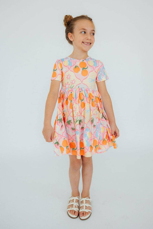 Girls colorful twirl pocket dress with short sleeves featuring fruit print for young kids